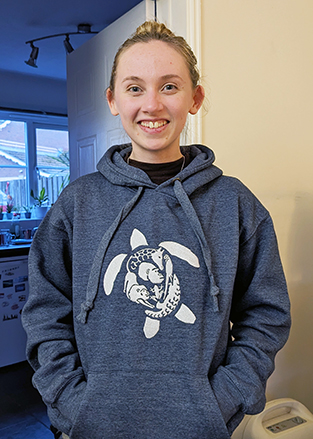 girl standing with hands in pockets